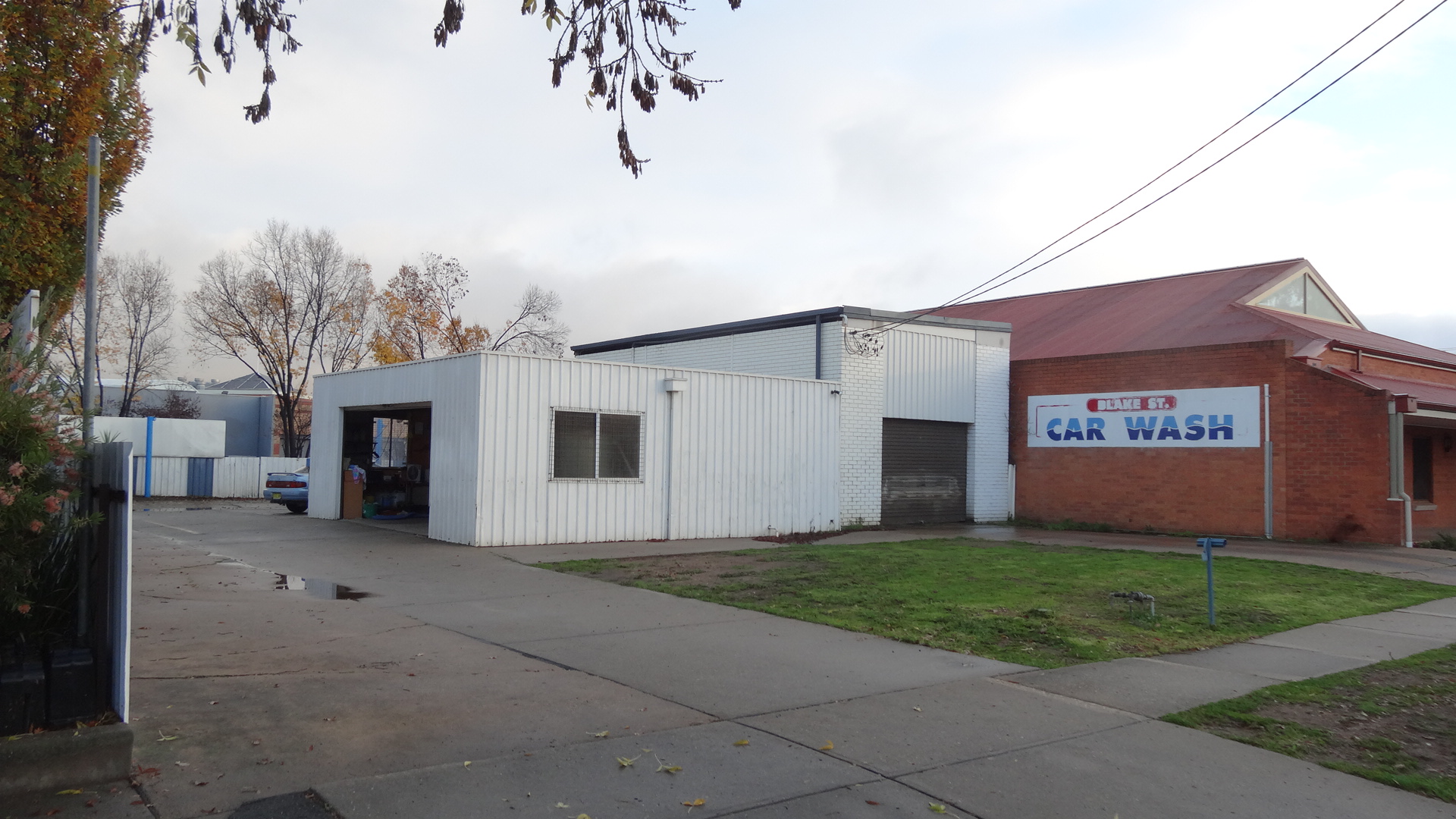 The Blake Street Car Wash premises in Wagga Wagga, with the painted sign on the brick end wall
